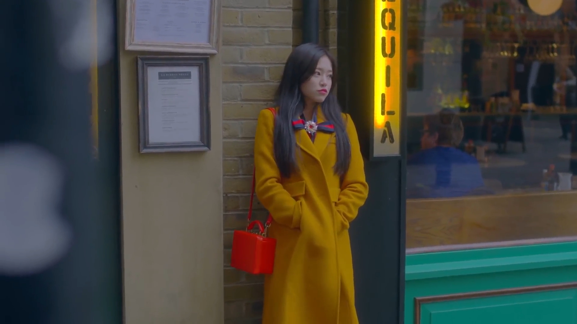 Hyunjin leaning against a wall.